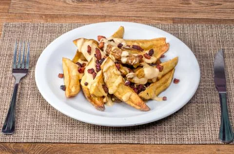 Fried potato with cheddar and bacon Stock Photos
