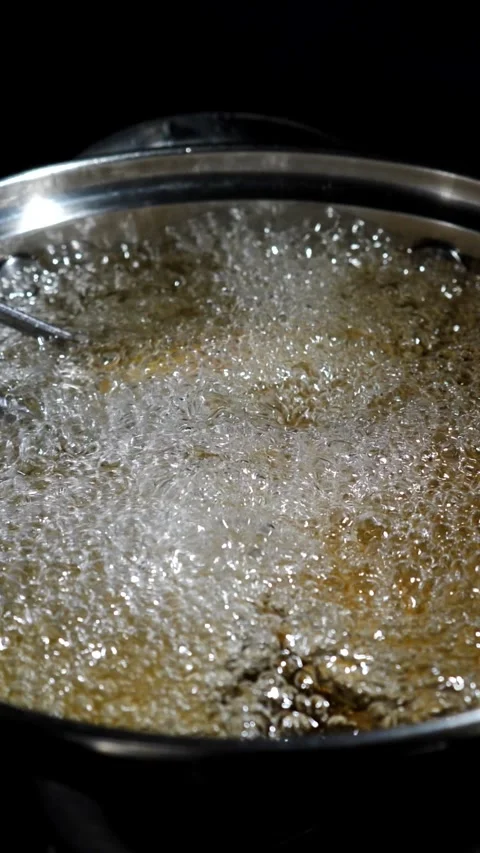 Fried potato pancakes with crust being turned over with culinary tweezers in Stock Footage 308821959