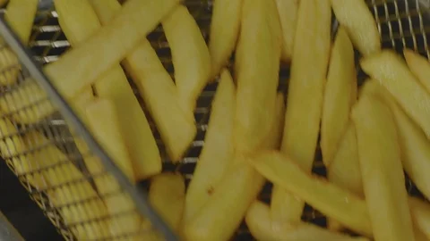 Fried potatoes are dipped in boiling oil Stock Footage 102510320