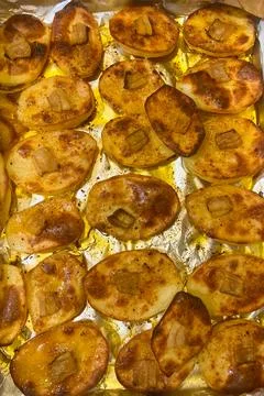 Fried potatoes with bacon in the oven Stock Photos