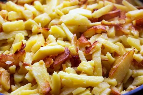 Fried potatoes in close-up, cooking. selective focus. Stock Photos