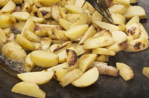Fried potatoes on the grill Stock Photos