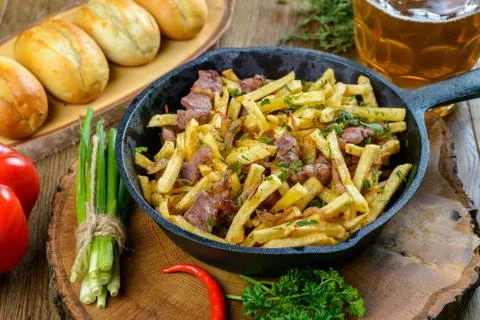 Fried potatoes with meat Stock Photos