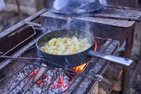 Fried potatoes on an open fire Stock Photos