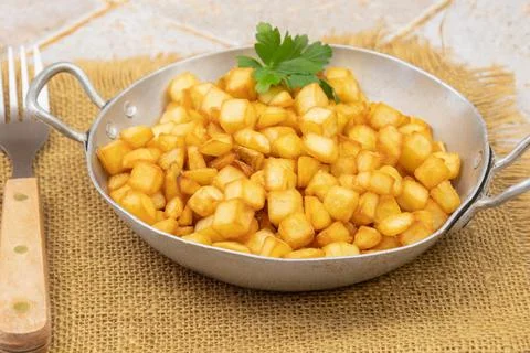 Fried potatoes in pan Stock Photos