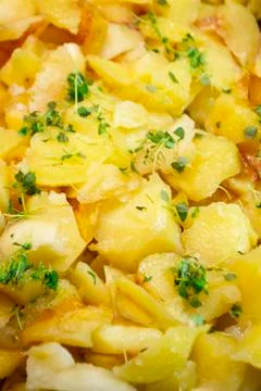 Fried potatoes texture with herbs, vertical image Stock Photos