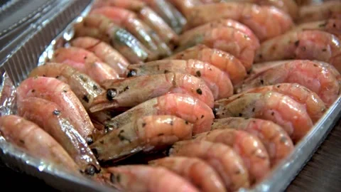 Fried prawns on foil in plastic box on table in restaurant kitchen. HD Stock Footage 141592176
