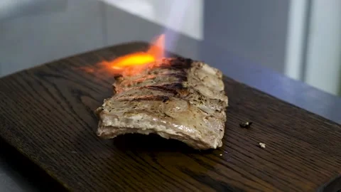 Fried ribs with rosemary, potatoes rustic, onion, sauce on wooden round Board. Stock Footage 142939671