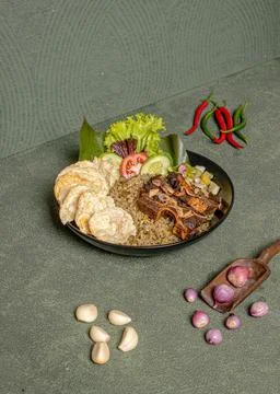 Fried Rice With Beef, Served With Vegetable Salad And Crackers On A Black P.. Stock Photos