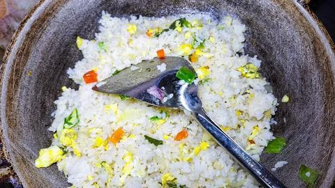 Fried rice with egg on a pan. Stock Photos
