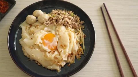 Fried rice with egg, vegetables, and ground meat in black bowl Stock Photos