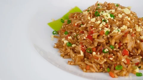 Fried rice, mixed with chopped vegetables, egg, soy sauce and sesame seeds Stock Footage 95674140