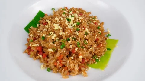 Fried rice, mixed with egg, soy sauce and sesame seeds, served in Restaurant Stock Footage 95673942
