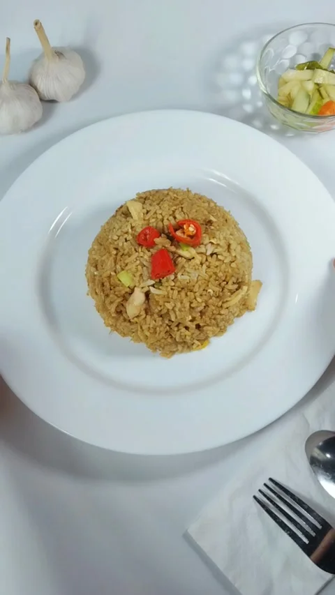 Fried rice is served and presented. Vertical shot from above for an Asian culina Stock Footage 329375760