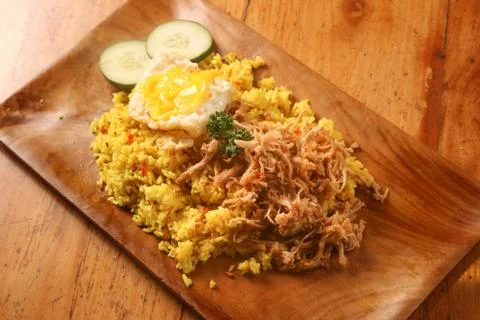 Fried rice served with egg and cucumber slices Stock Photos