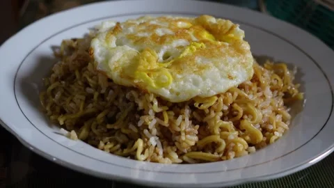 Fried rice served on a plate with an egg on top Stock Footage 306670184