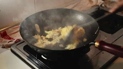 Fried Rice Stir Fried in a Black Iron Wok with High Heat Vidéo 345341440