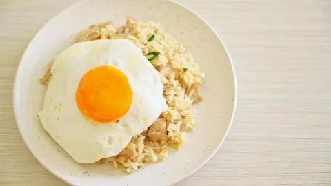 Fried rice with sunny side up egg on white plate Stock Photos