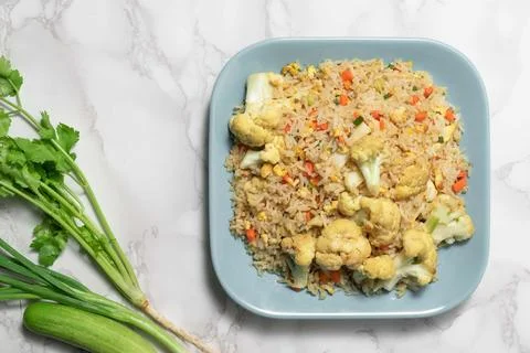 Fried rice with vegetable and egg in plate on white background. Stock Photos