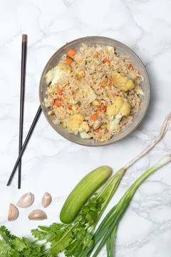Fried rice with vegetable and egg in bowl on white background. Stock Photos