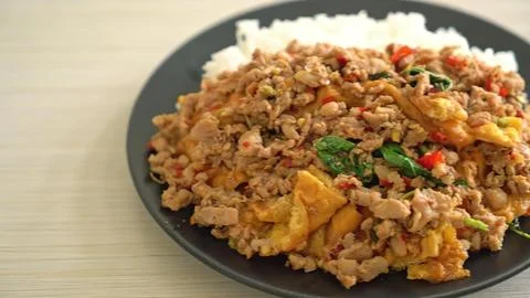 Fried rice with vegetables and egg on black plate Stock Photos