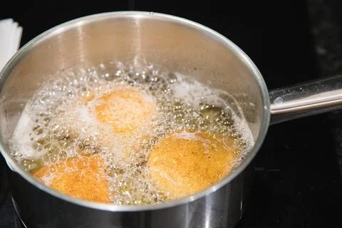 Fried rissois are lifted from hot oil and drained on paper towels Stock-Fotos
