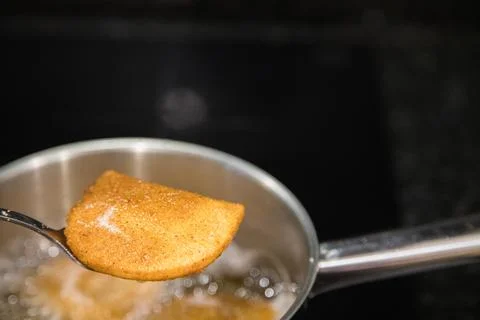 Fried rissois are lifted from hot oil and drained on paper towels Stock-Fotos
