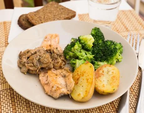 Fried river trout fillet with a complex side dish of broccoli, baked potatoes Foto stock