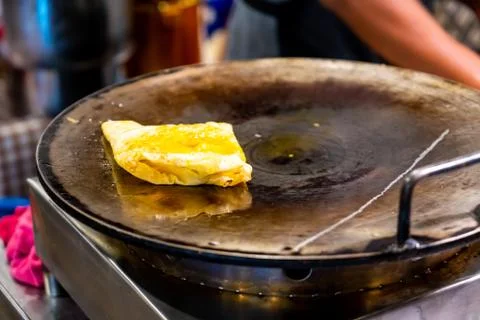 Fried roti on pan Stock Photos