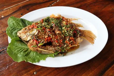 Fried ruby fish topped with sweet,sauer and hot sauce 写真素材