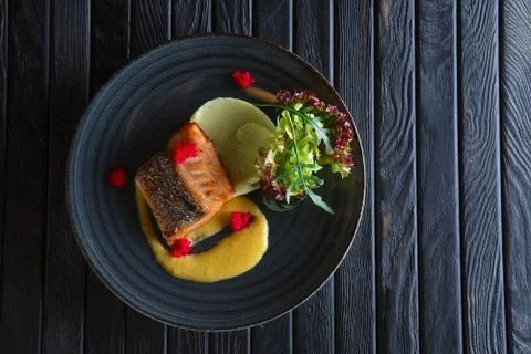 Fried salmon with mashed potato mixed with wasabi and decorated with flying f Stock-Fotos