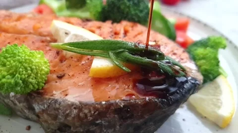 Fried salmon piece on a plate Stock Footage 144312703