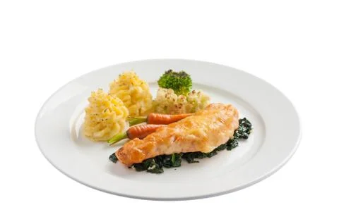 Fried salmon with spinach Stock Photos