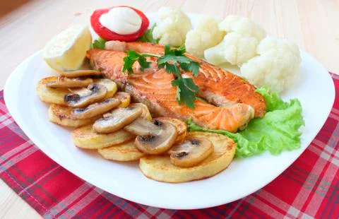 Fried salmon with vegetables Stock Photos