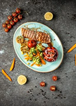 Fried salmon with vegetables on the table __ Stock Photos