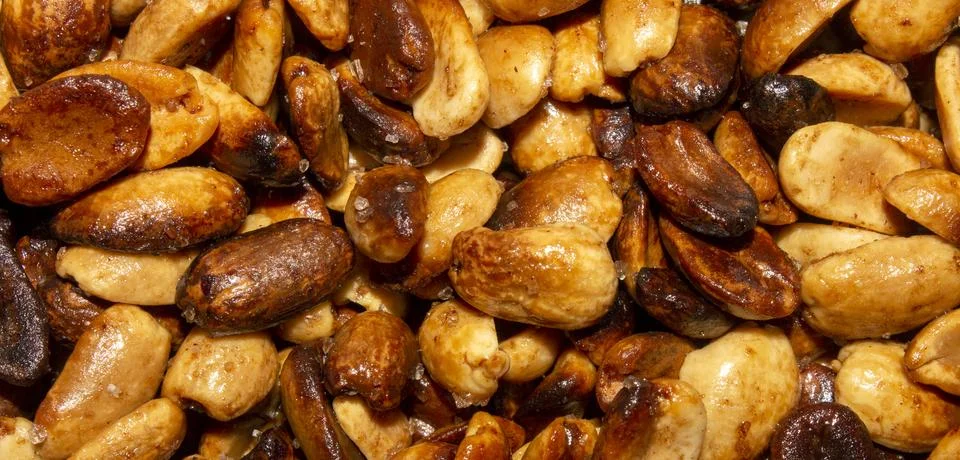 Fried salted peanuts.The texture of roasted peanuts.Peanuts for beer. Stock Photos
