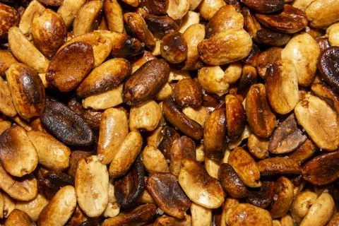 Fried salted peanuts.The texture of roasted peanuts.Peanuts for beer. Stock Photos