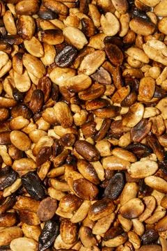 Fried salted peanuts.The texture of roasted peanuts.Peanuts for beer. Stock Photos