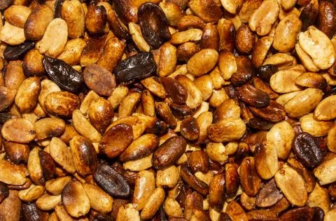Fried salted peanuts.The texture of roasted peanuts.Peanuts for beer. Stock Photos