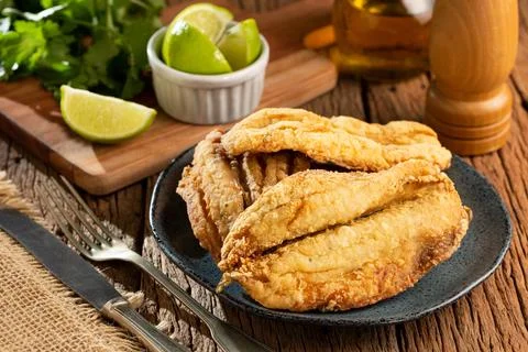 Fried sardines in the plate on the table. Stock Photos