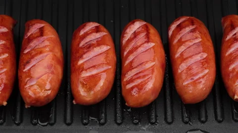 Fried sausages on grill top view. Grill sausages. Sliding shot. 4K UHD video Stock Footage 158074341