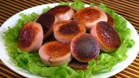 Fried sausages with lettuce Stock Footage 91857230
