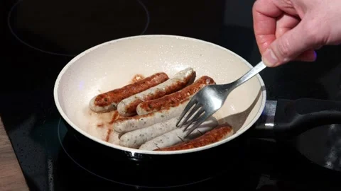 Fried sausages in a pan. Stock Footage 157368910