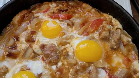 Fried scrambled eggs with bacon in a pan Stock Footage 195938704