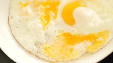 Fried  scrambled eggs close-up. View from above. Healthy protein breakfast. Stock Footage 238722403