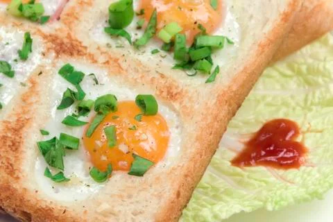 Fried scrambled quail eggs in bread toast with vegetables. Creative breakfast Stock Photos