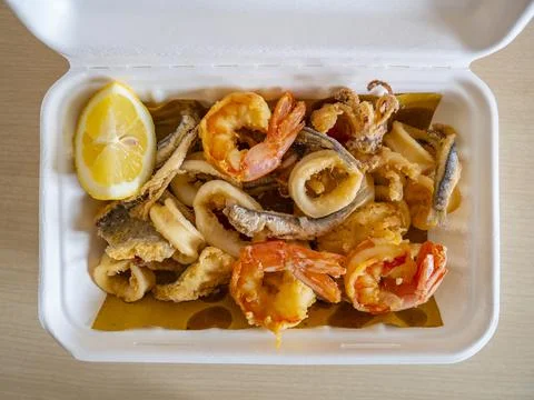 Fried seafood in compostable biodegradable packaging take out container Stock Photos