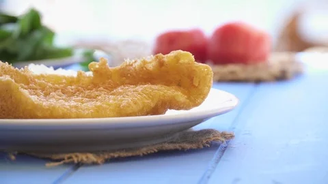 Fried seafood with lemon and arugula on blue table by the sea Stock Footage 80309527