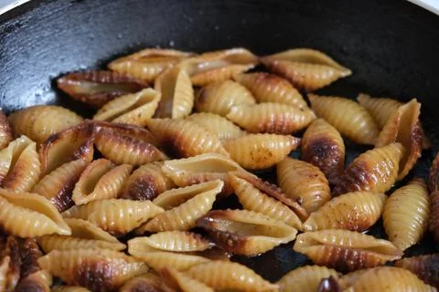 Fried shell pasta in a pan Stock Photos