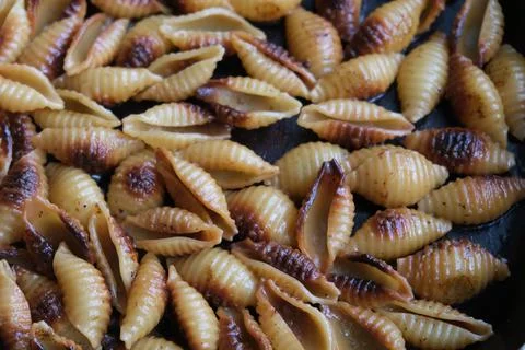 Fried shell pasta in a pan Stock Photos